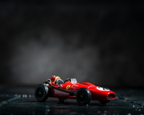 red ferrari f 1 on black surface