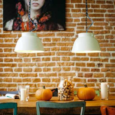 rectangular brown wooden table with two pumpkin on top
