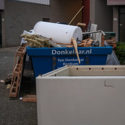 A pile of junk sitting outside of a building